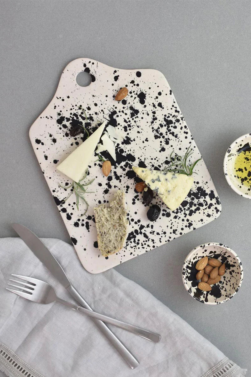 Handmade ceramic cheese board with hand-painted black splatters by OWO Ceramics