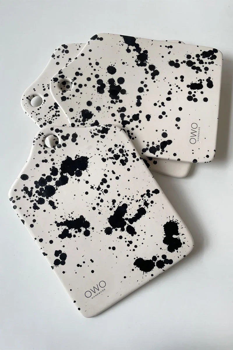 Handcrafted pottery cheese platter boards with hand-painted black splatters